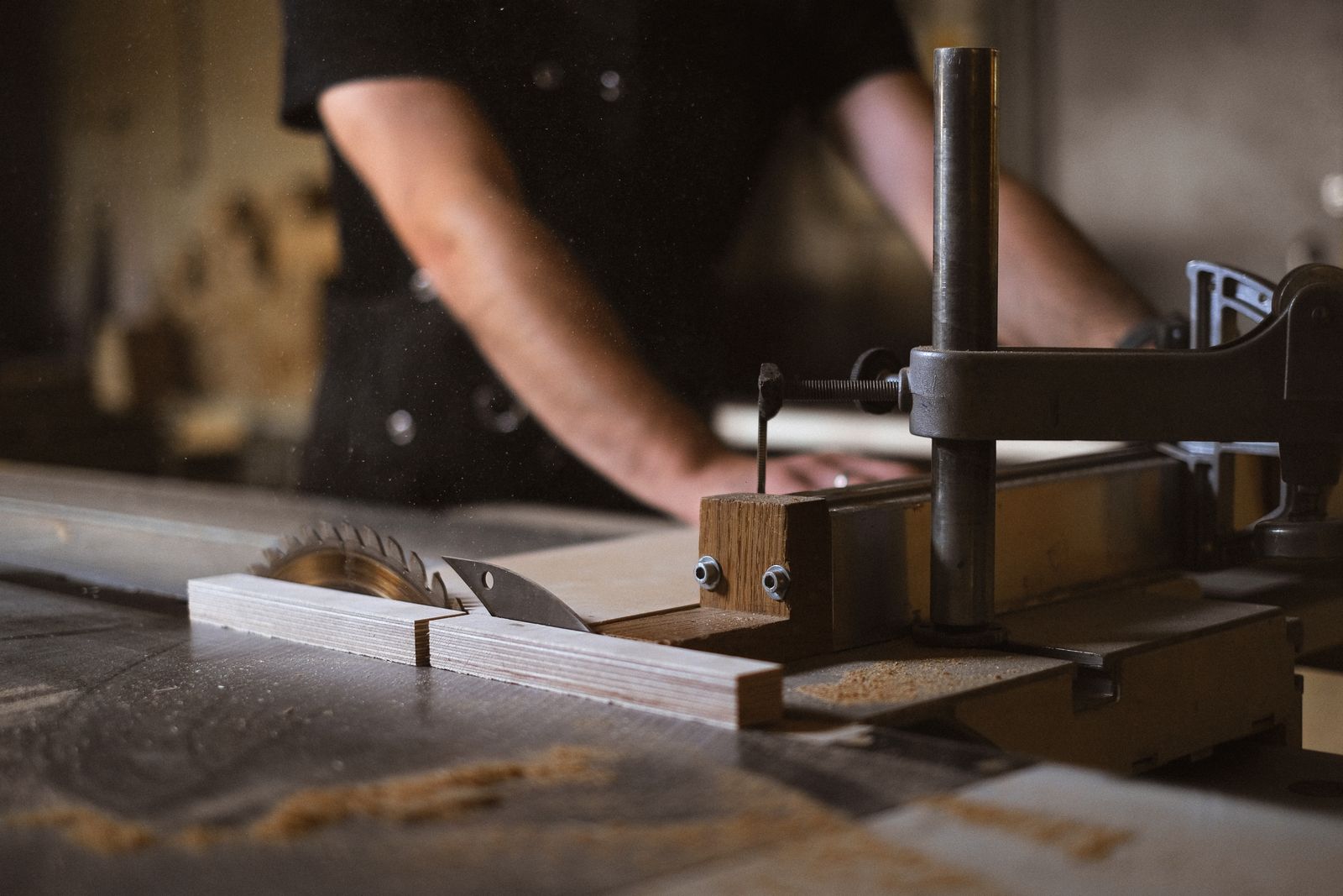 Joiner working with a table saw on custom millwork — the same idea applied to the platforms your fitout business already runs