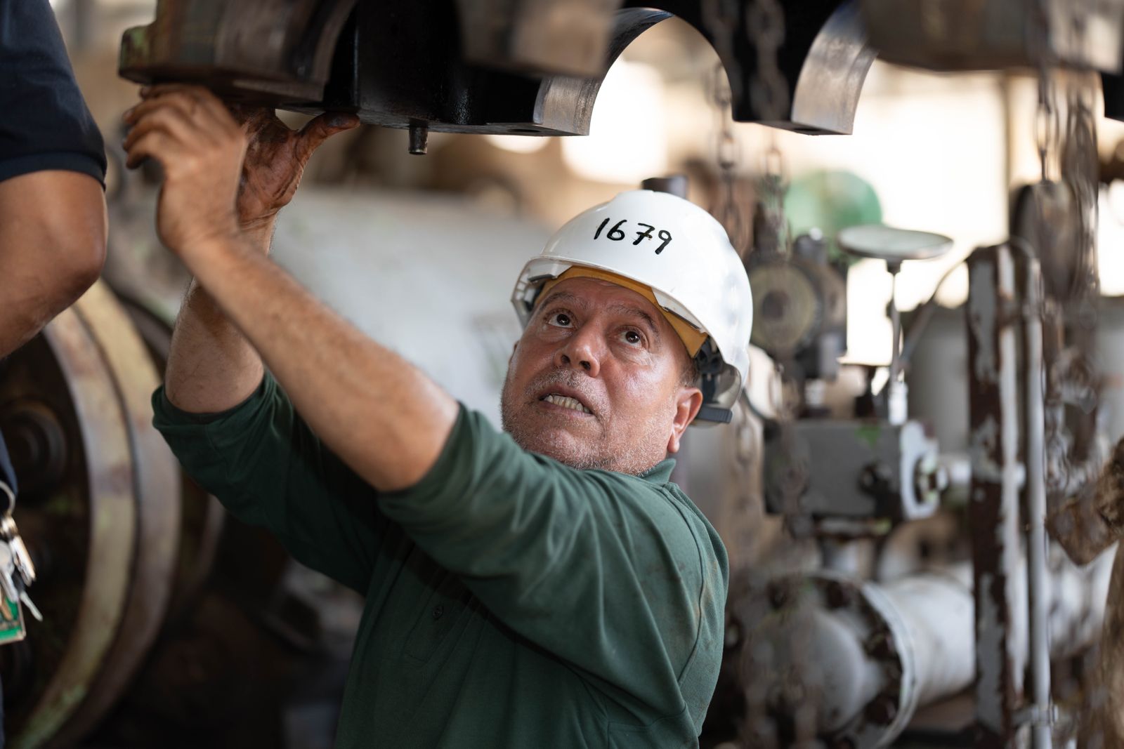 Engineer inspecting industrial gas machinery — the same idea applied to the platforms your gas business already runs