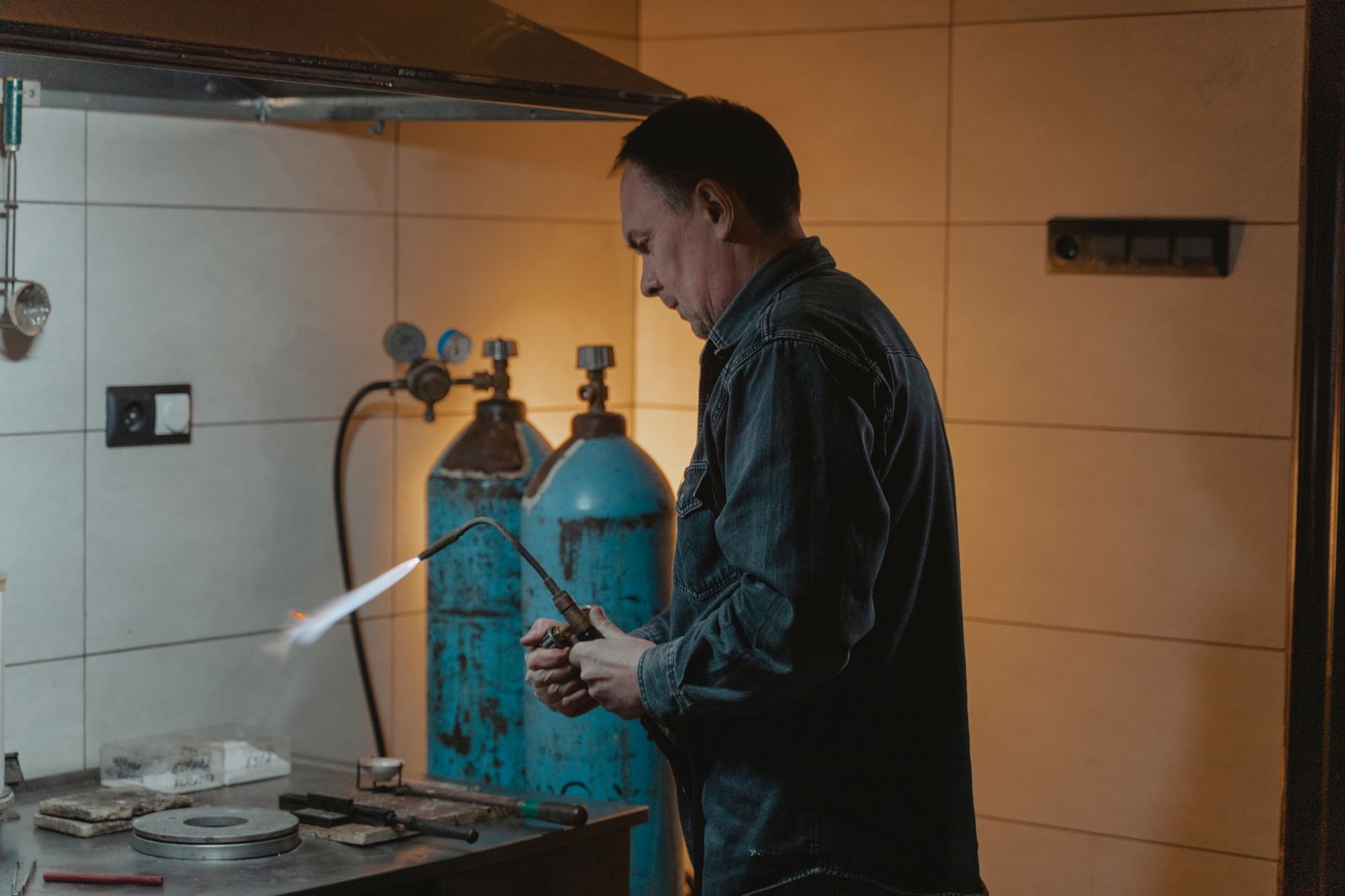 Gas technician using a welding torch — the kind of Type A and B work that has strict licence-class requirements