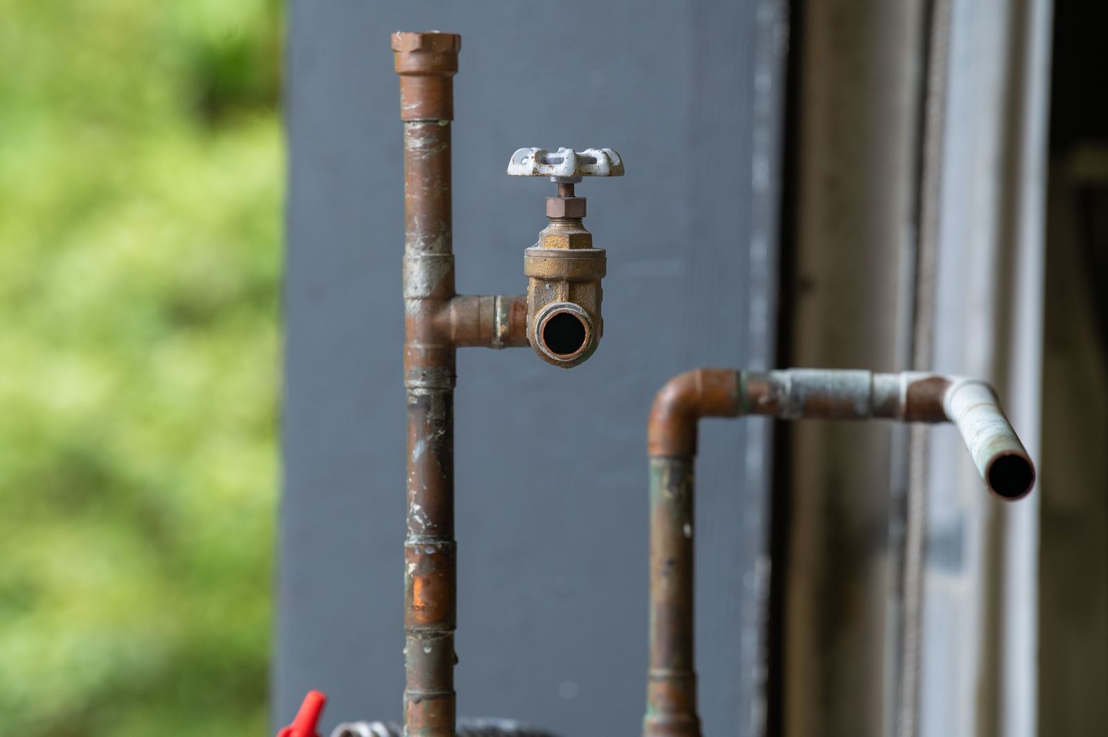 Old corroded water pipe — the kind of asset that needs before-and-after evidence captured against the job