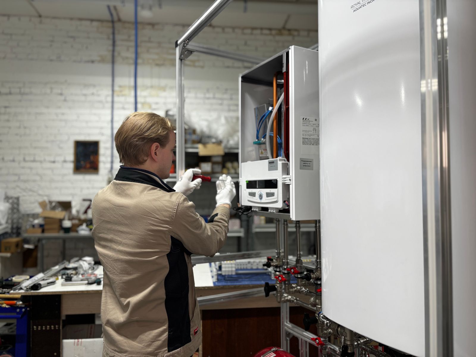 Plumbing technician working on a heating and hot water system — AI applied to the parts of the workflow where it removes real work