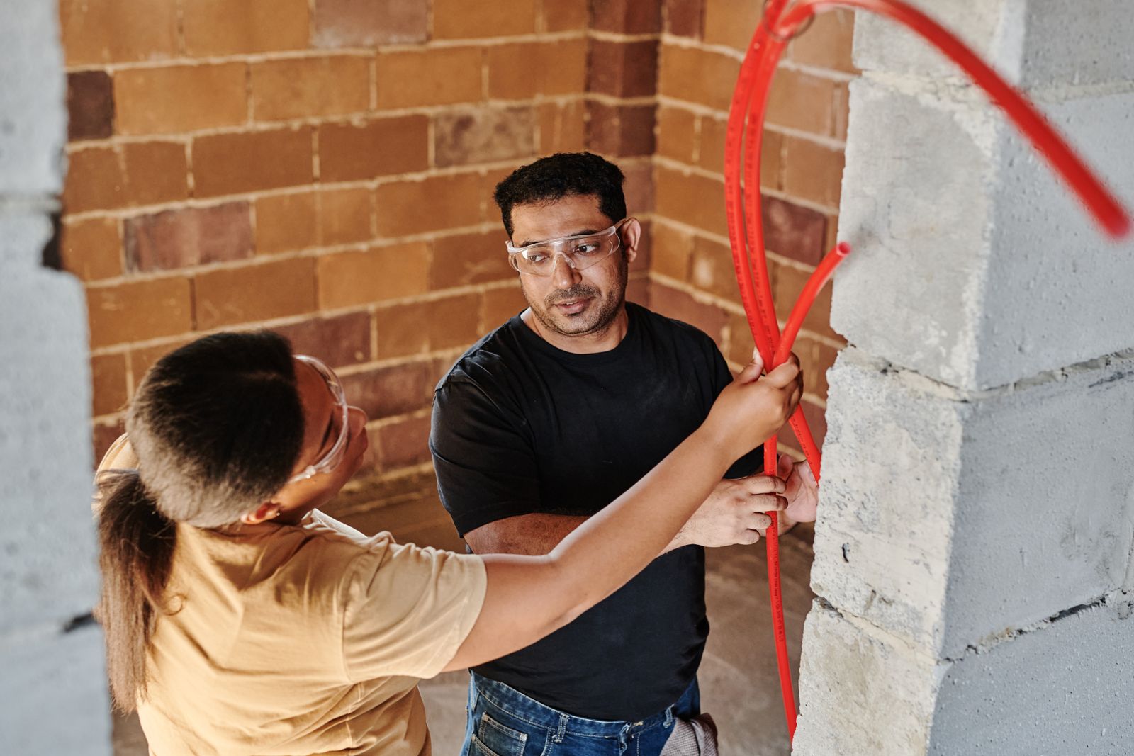 Two plumbers fitting pipework together — the same idea applied to the platforms your plumbing business already runs